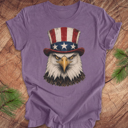 Purple t-shirt with an eagle wearing an Uncle Sam hat on a wooden surface