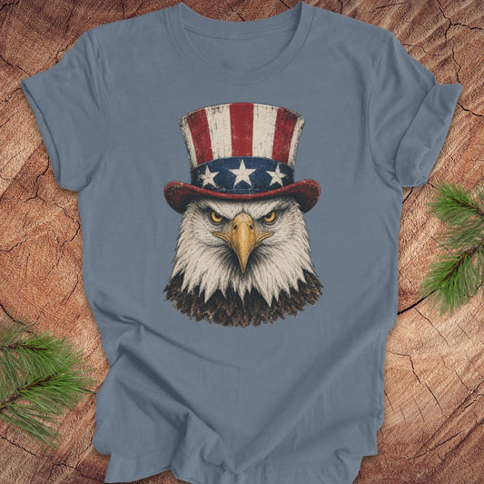 Blue t-shirt with an eagle wearing an Uncle Sam hat on a wooden surface
