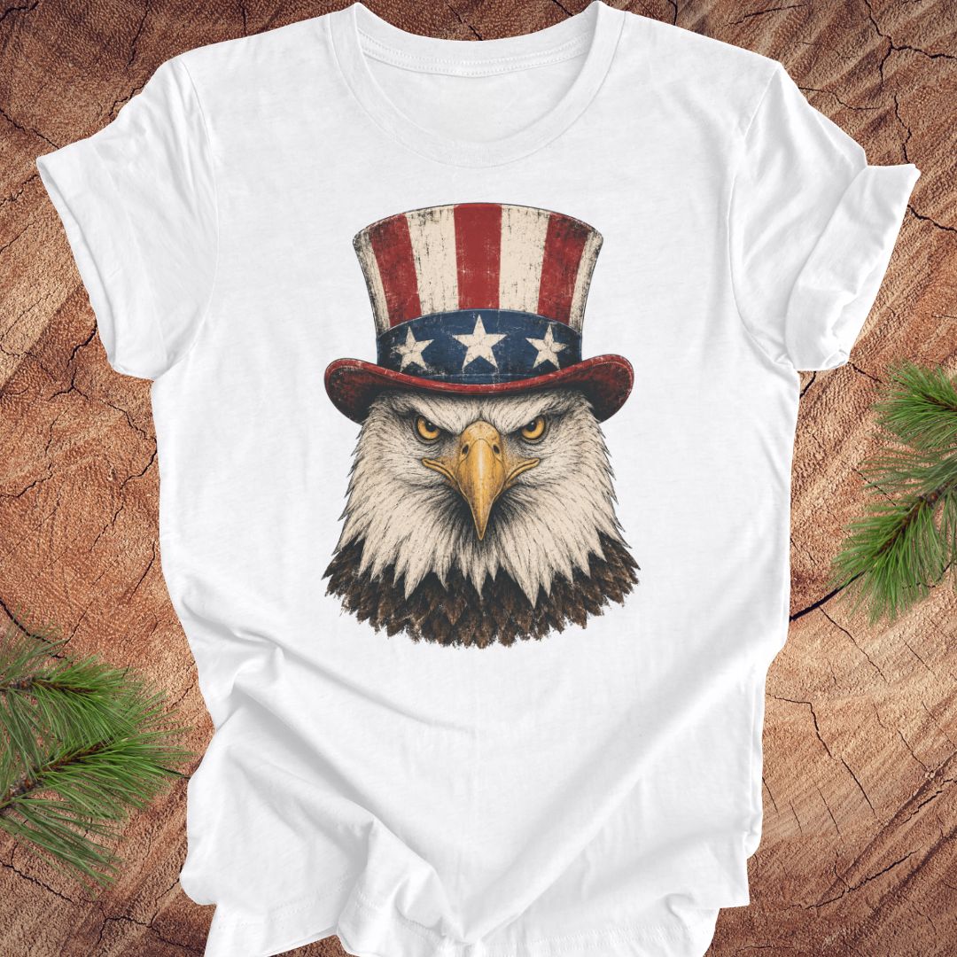 White t-shirt with an eagle wearing an Uncle Sam hat on a wooden surface