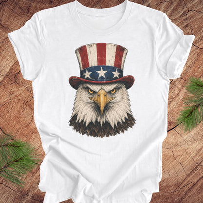 White t-shirt with an eagle wearing an Uncle Sam hat on a wooden surface