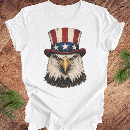 White t-shirt with an eagle wearing an Uncle Sam hat on a wooden surface