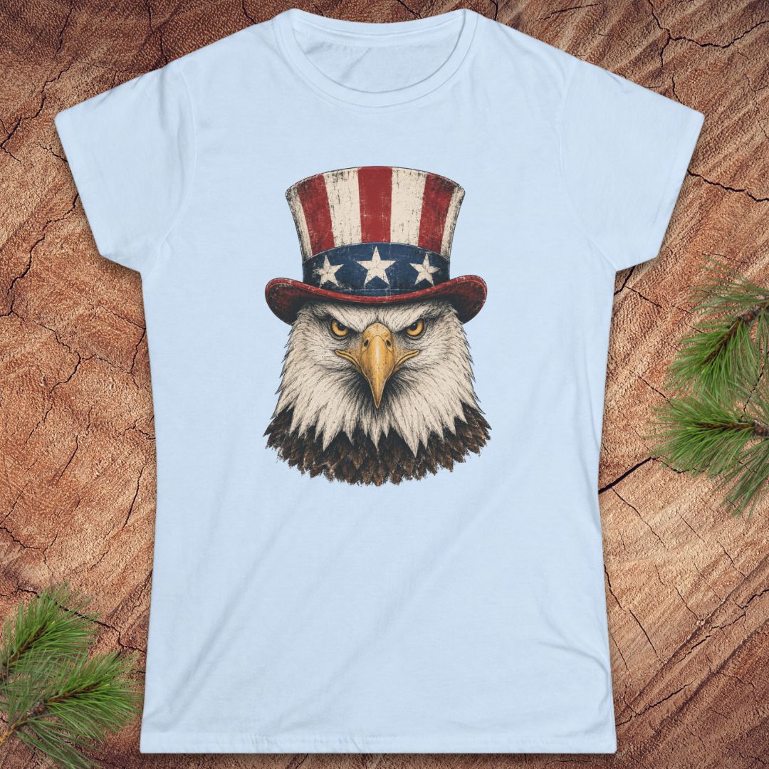 Light blue t-shirt with an eagle wearing a top hat on a wooden surface