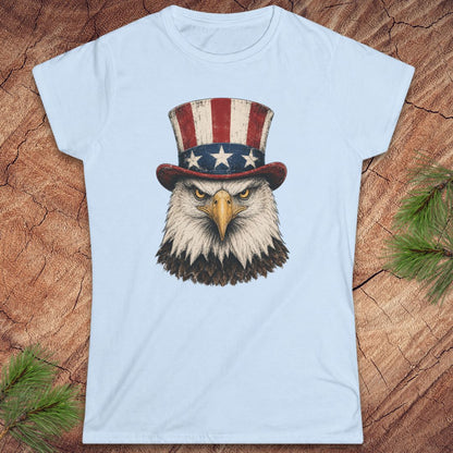 Light blue t-shirt with an eagle wearing a top hat on a wooden surface