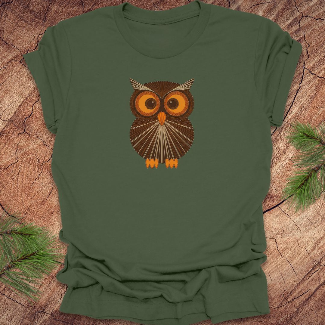 Green t-shirt with a vintage string art owl in browns and oranges on a wood background.