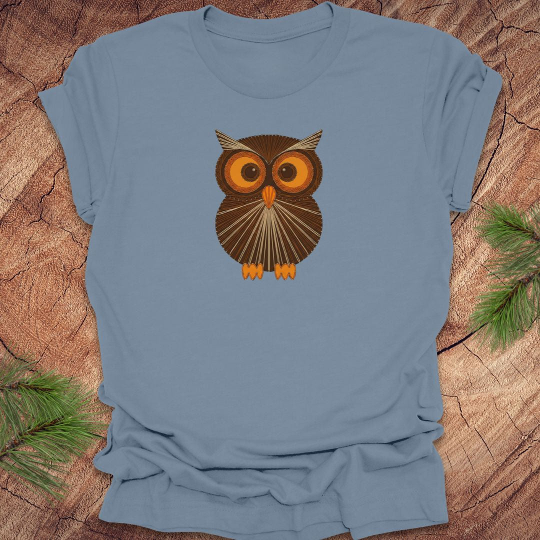 Steel blue t-shirt with a vintage string art owl in browns and oranges on a wood background.