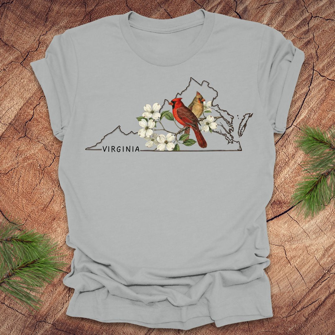 Gray t-shirt with Virginia map and cardinal design on a wooden surface