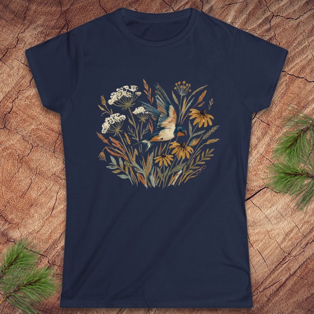 Navy blue t-shirt with floral and bird design on a wooden surface