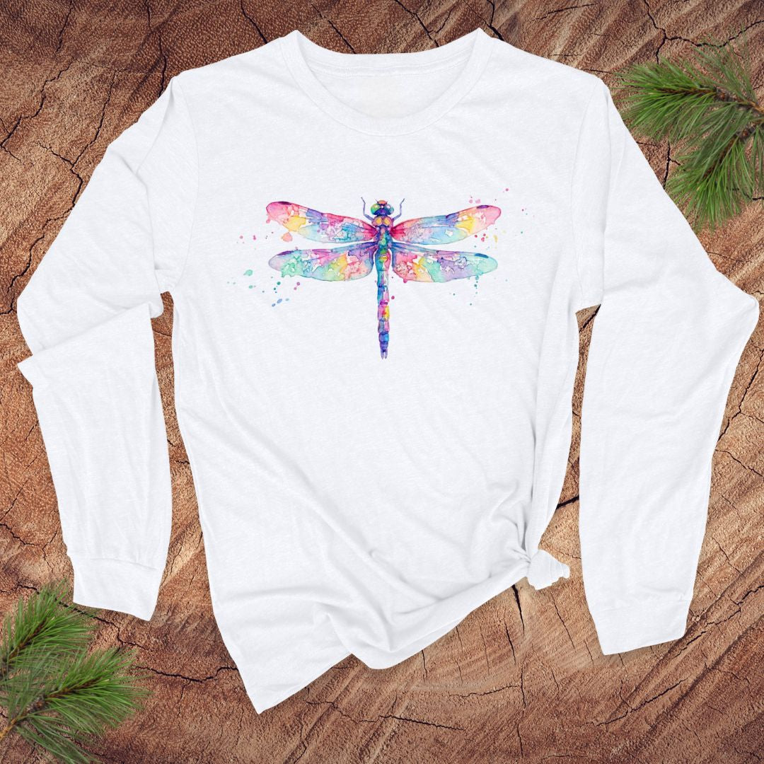 White long-sleeve shirt with a watercolor dragonfly design on a wooden surface.