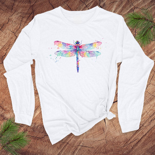 White long-sleeve shirt with a watercolor dragonfly design on a wooden surface.