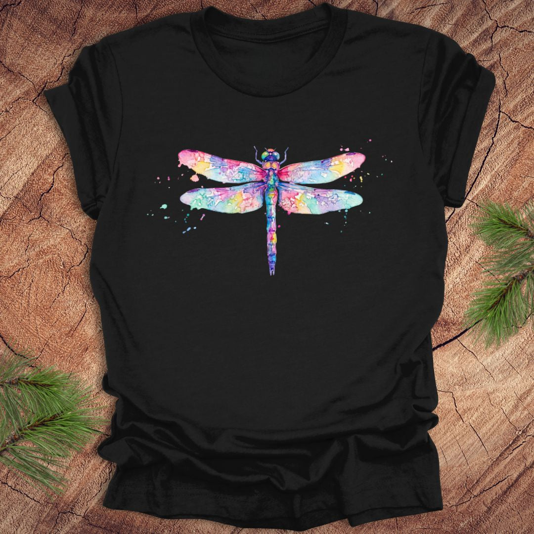 Black t-shirt with a hand painted pastel watercolor dragonfly on a wood background.