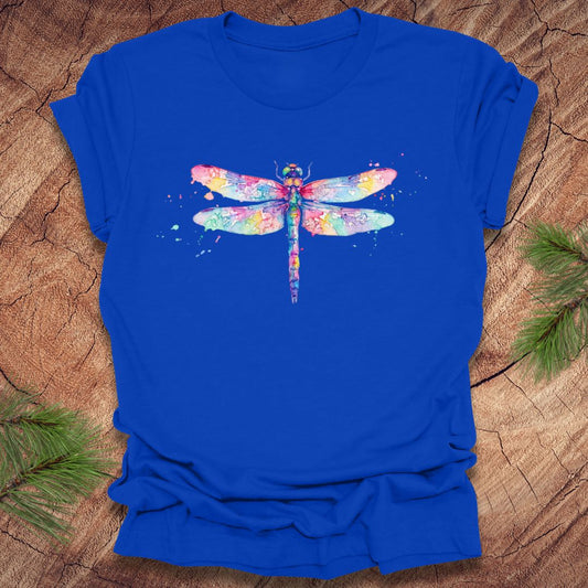 Royal blue t-shirt with a hand painted pastel watercolor dragonfly on a wood background.