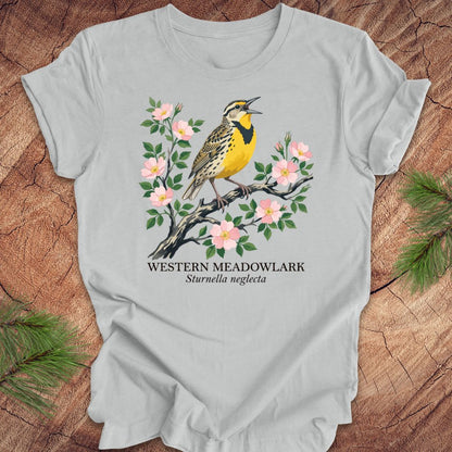 Gray t-shirt with a Western Meadowlark design on a wooden surface