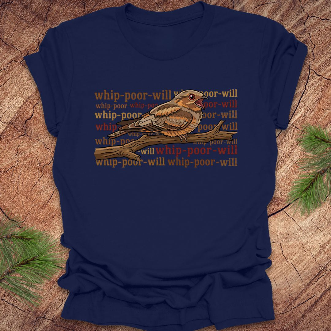 Navy blue t-shirt with a bird graphic and 'whip-poor-will' text on a wooden surface.