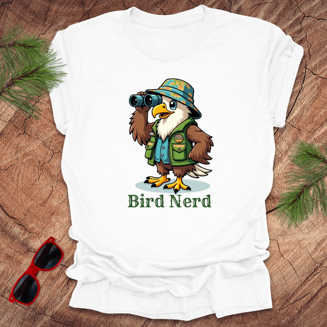 White t-shirt with an animated eagle in birdwatching gear with "bird nerd" text on a wood background.