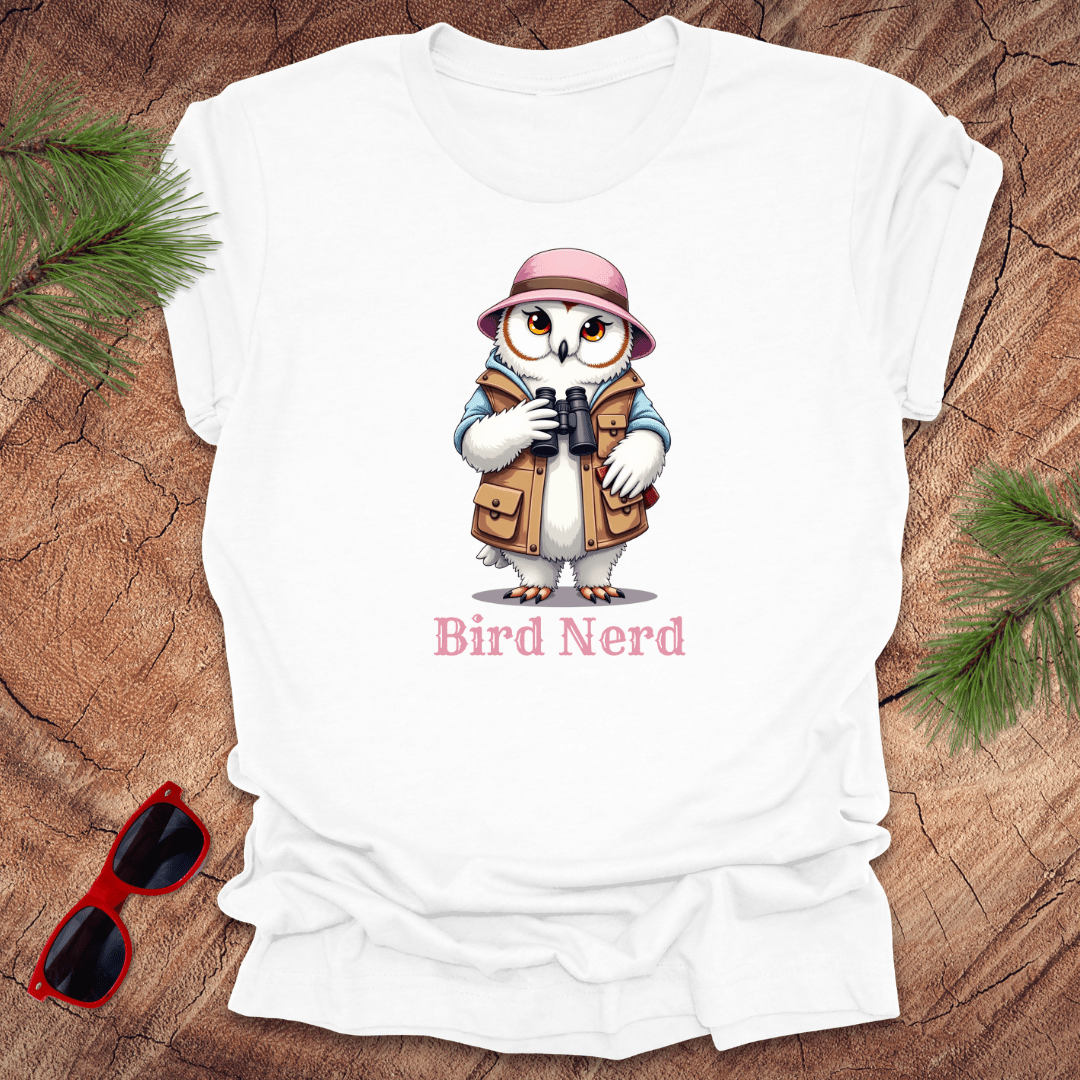 White t-shirt with an animated snowy owl in birdwatching gear with "bird nerd" text on a wood background.