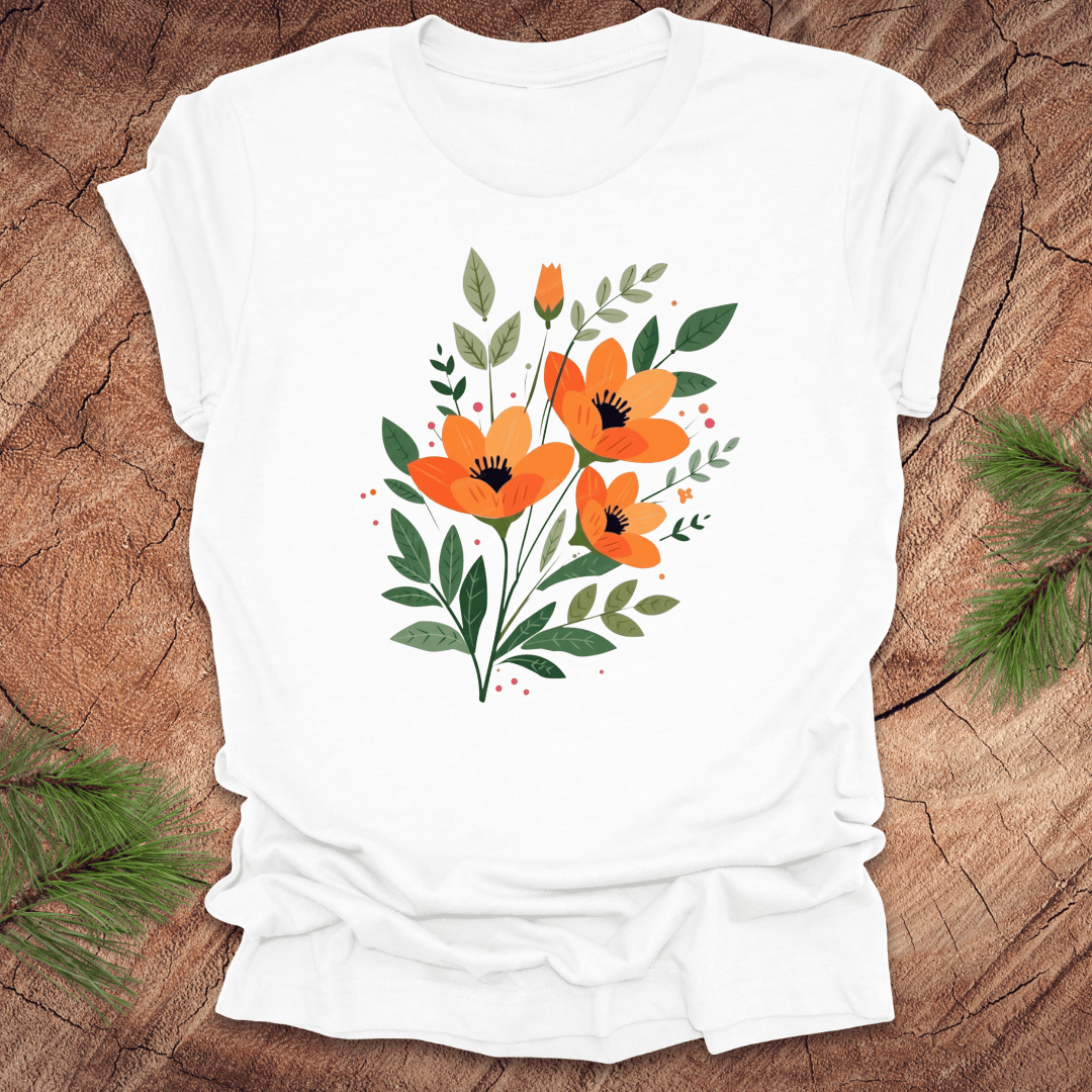 White t-shirt with orange floral design on a wooden surface
