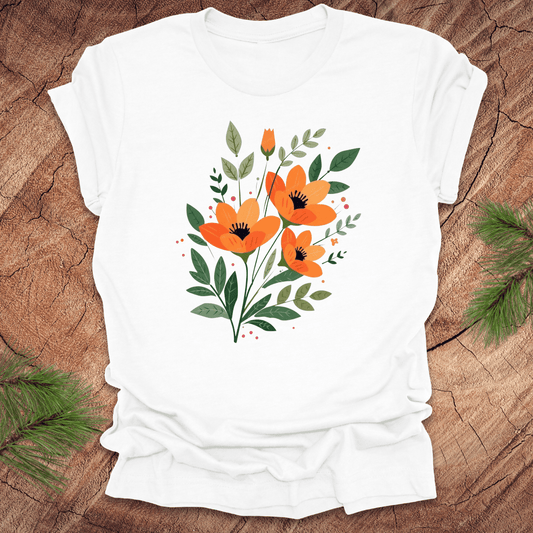 White t-shirt with orange floral design on a wooden surface