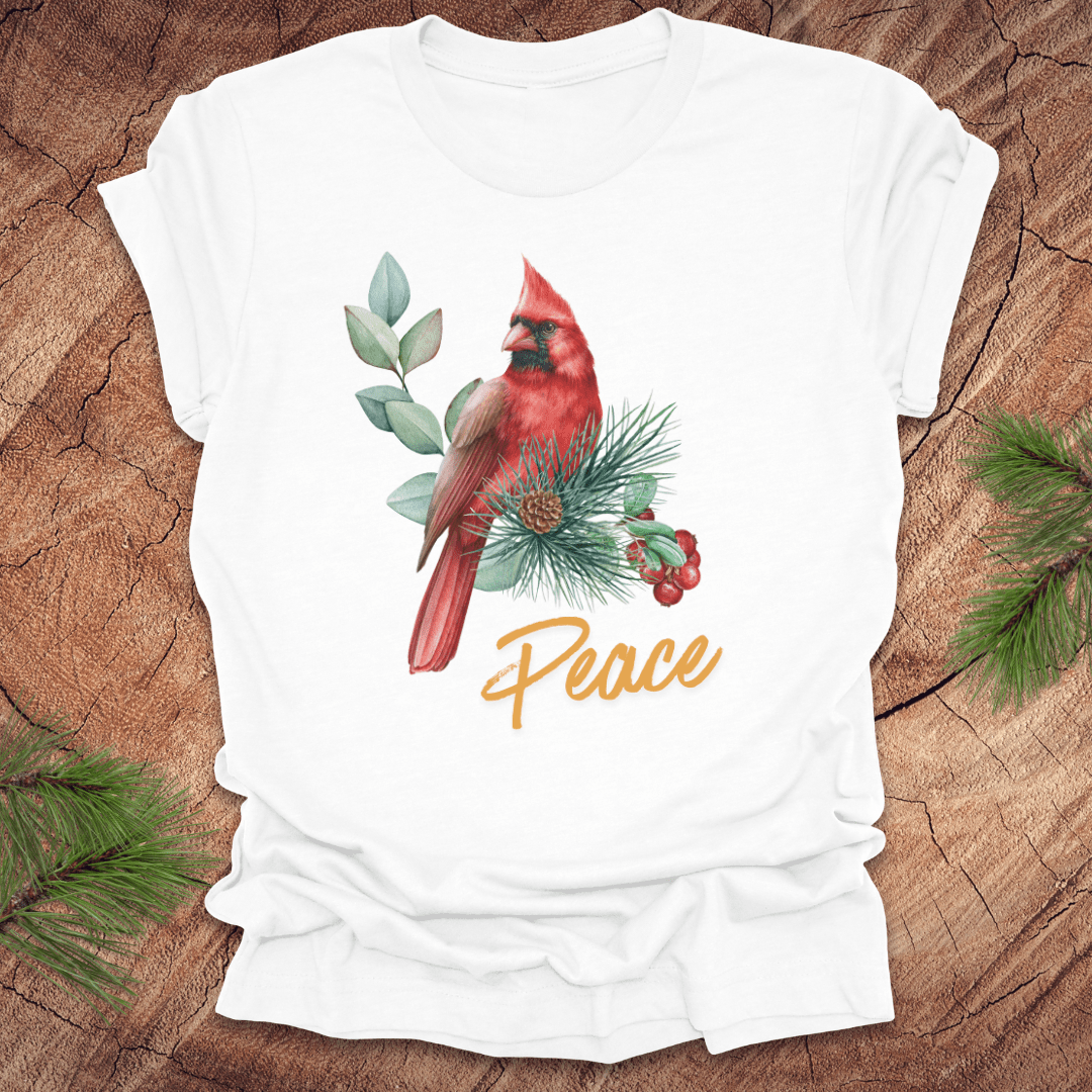 White t-shirt with a red cardinal and 'Peace' text on a wooden surface