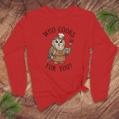 Red long-sleeve shirt with an owl graphic and text 'who cooks for you' on a wooden surface