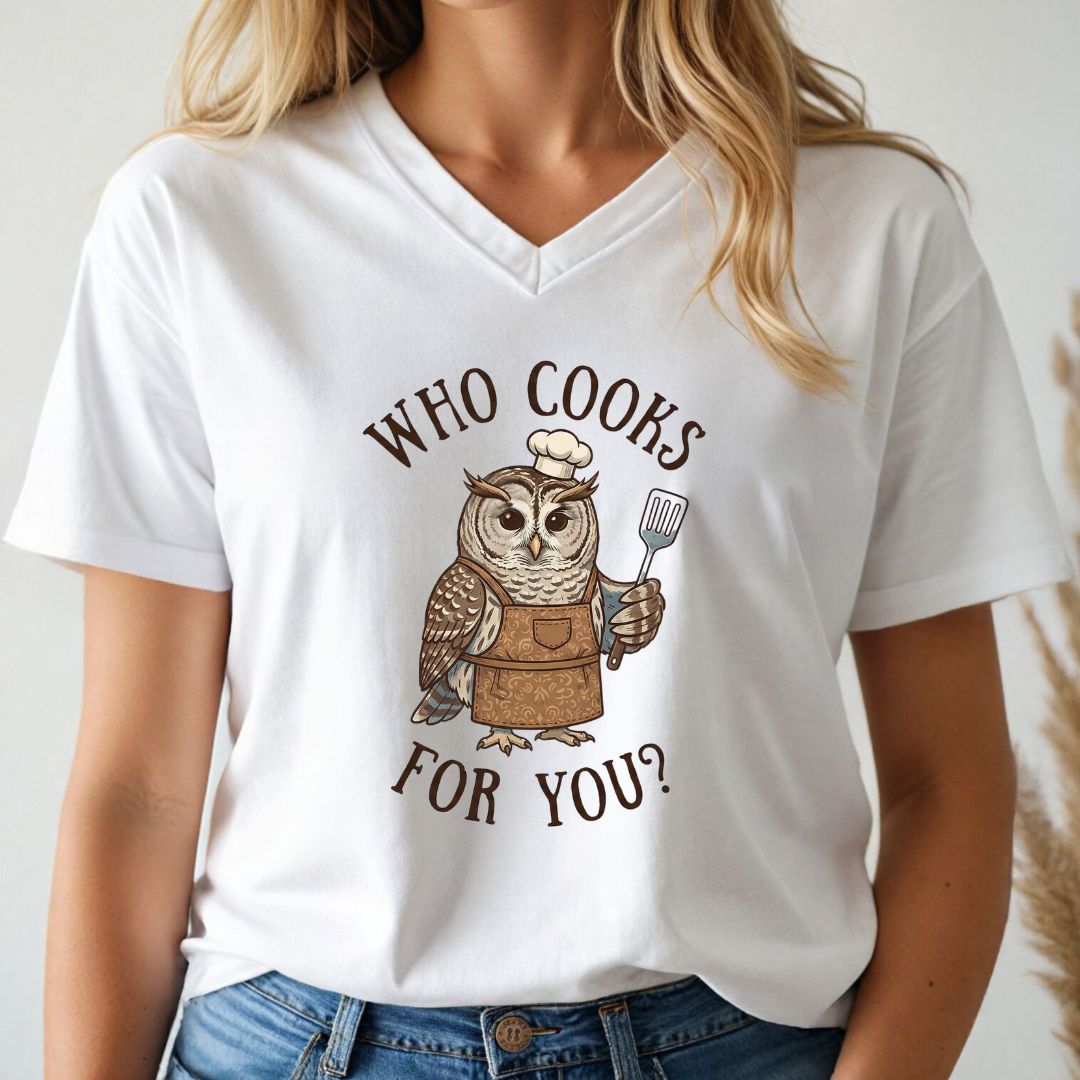 White v-neck t-shirt with an owl graphic and text 'WHO COOKS FOR YOU?' worn by a person.