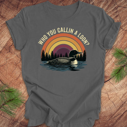 Gray t-shirt with a loon graphic and text 'who you callin a loon' on a wooden surface