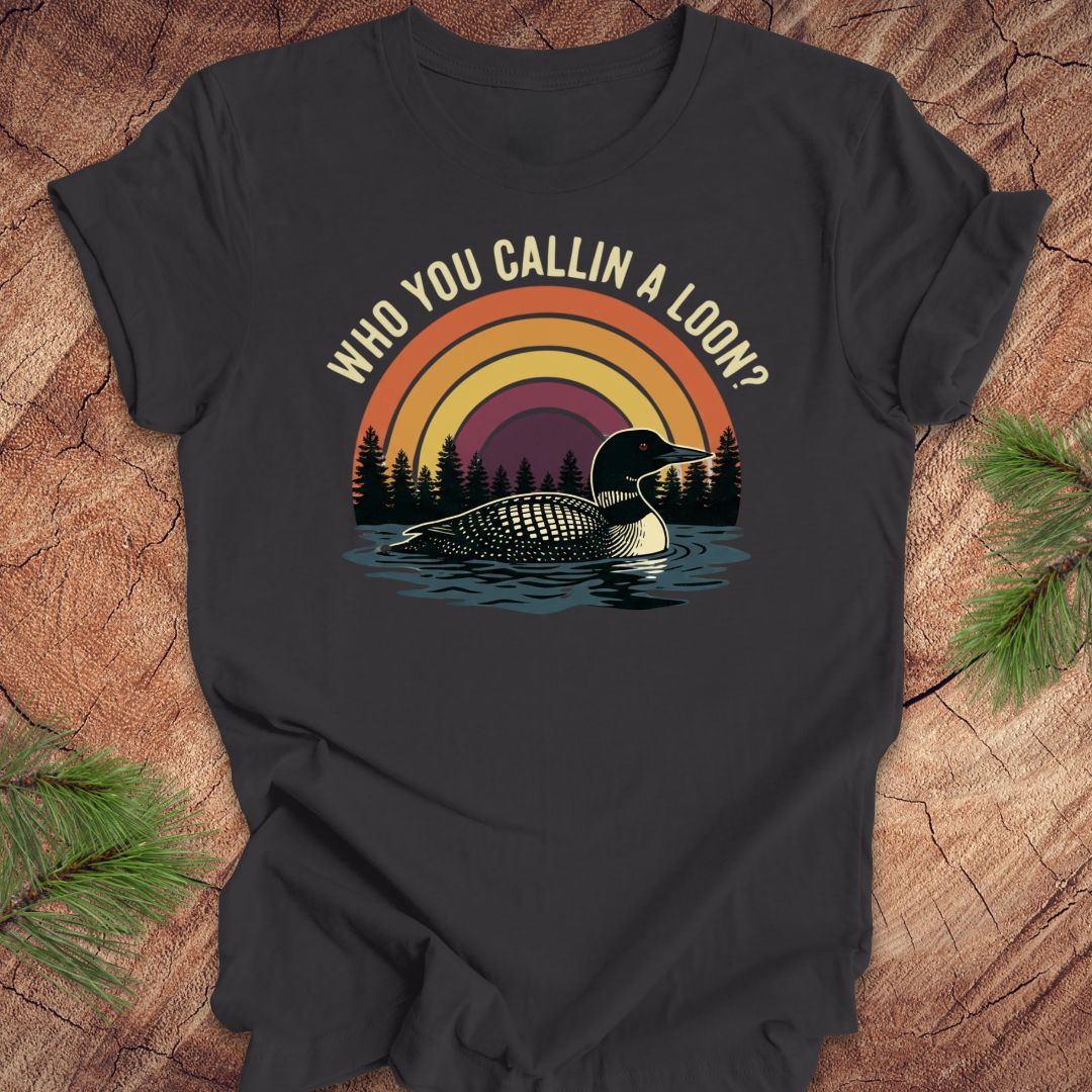 Dark gray t-shirt with a loon graphic and text 'who you callin a loon' on a wooden surface