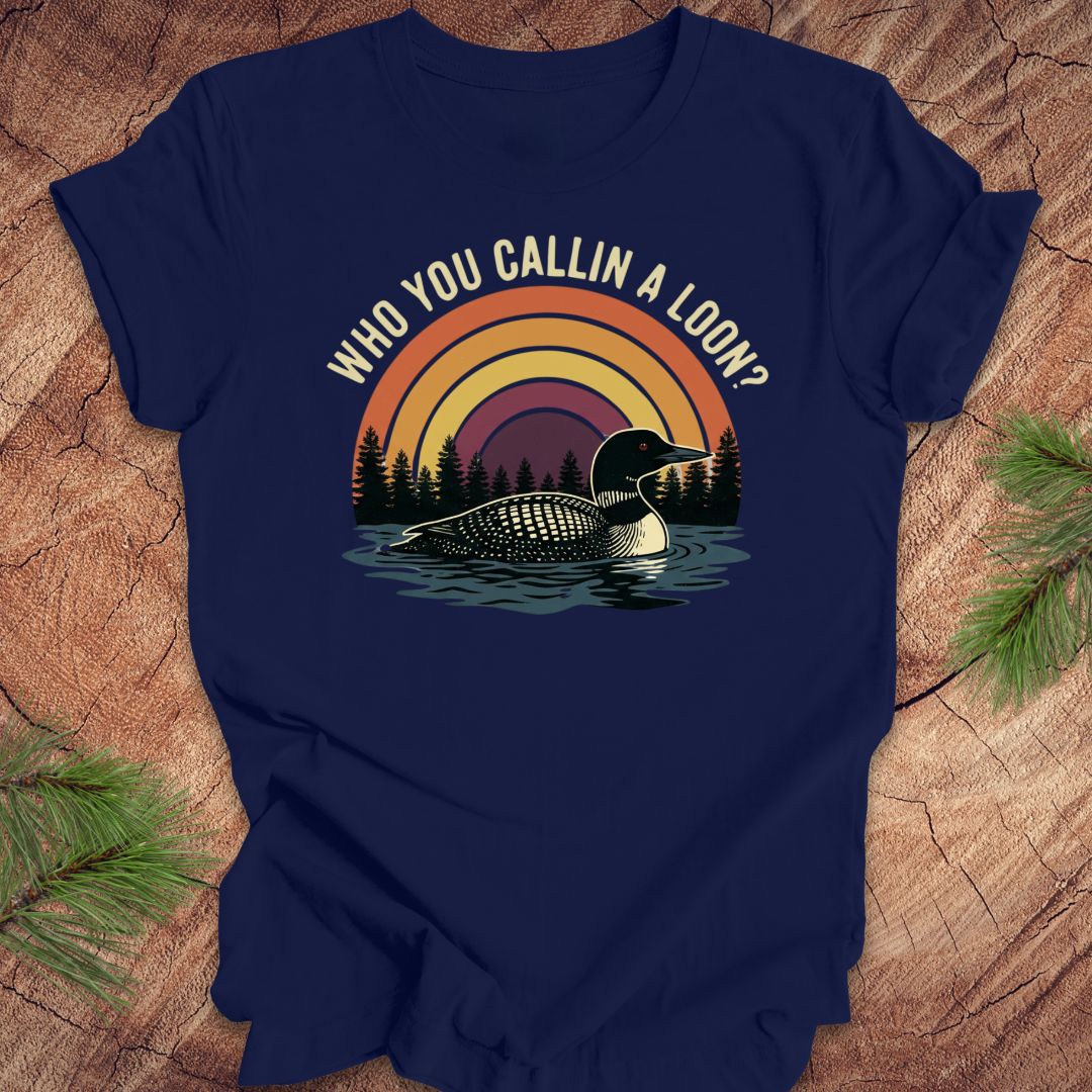 Navy blue t-shirt with a loon graphic and text 'who you callin a loon' on a wooden surface