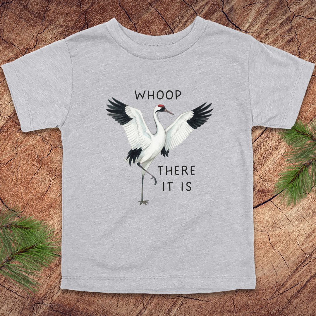 Gray t-shirt with a crane graphic and text on a wooden surface