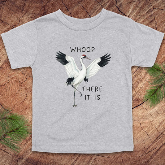 Gray t-shirt with a crane graphic and text on a wooden surface
