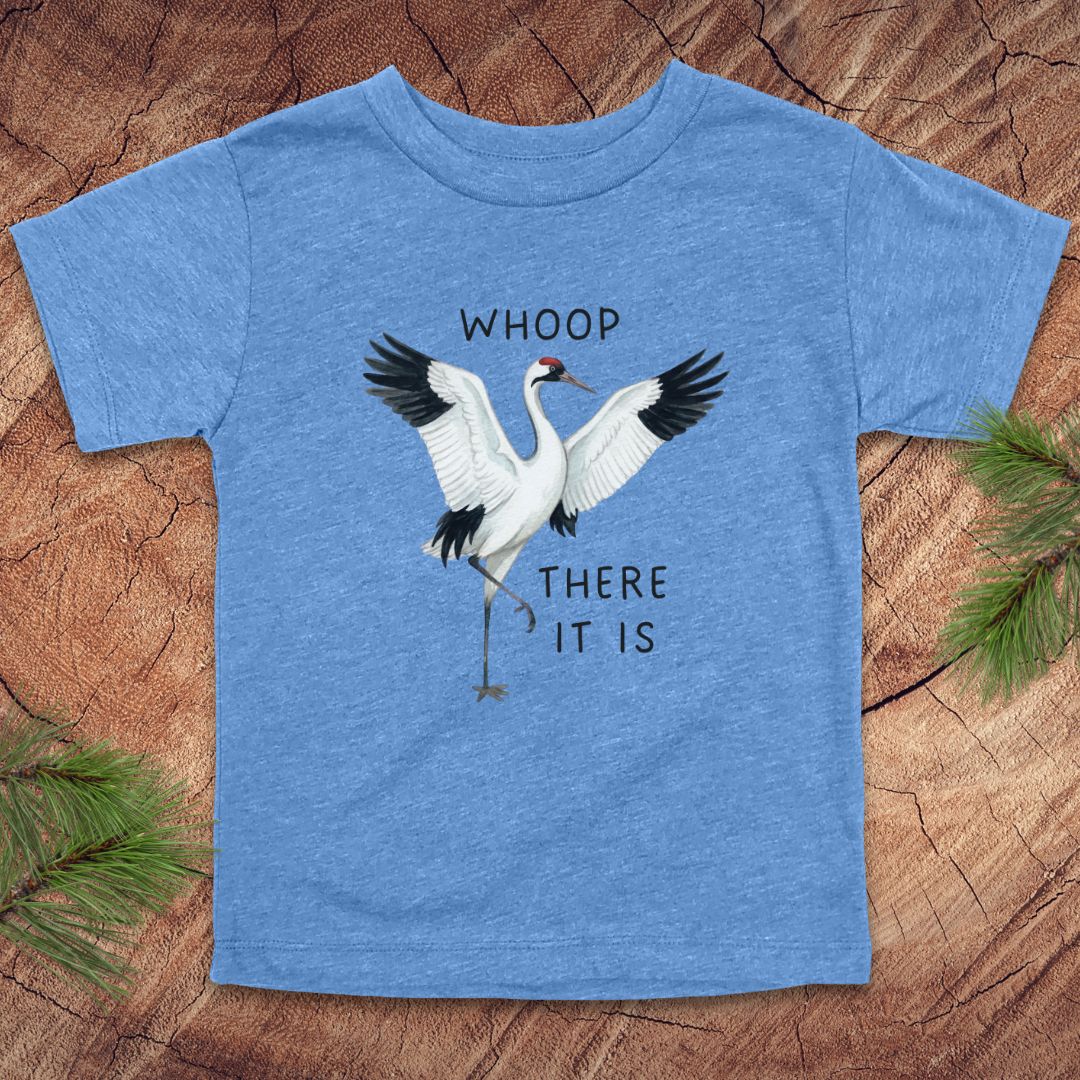 Blue t-shirt with a crane graphic and text on a wooden surface