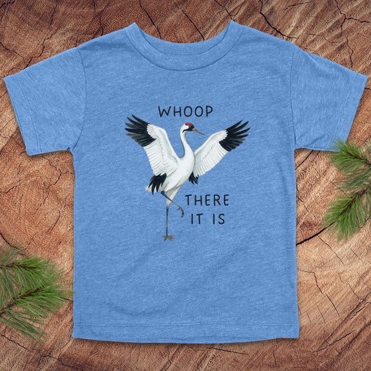 Blue t-shirt with a crane graphic and text on a wooden surface