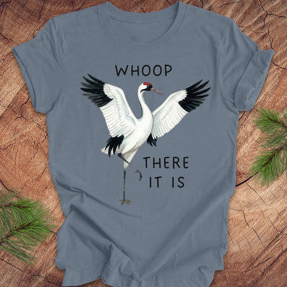 Blue t-shirt with a crane graphic and text, 'whoop there it is' on a wooden surface