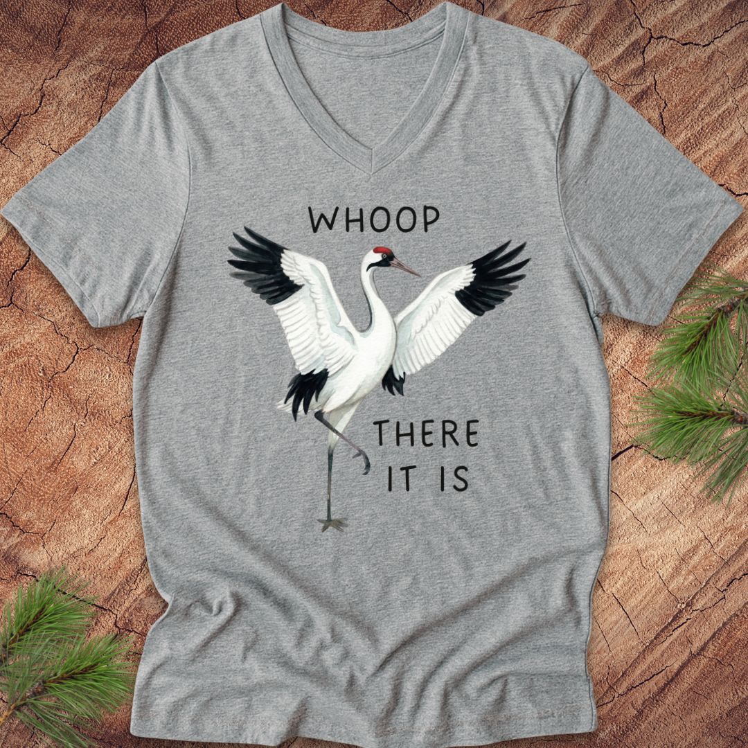 Gray t-shirt with a whooping crane graphic and text on a wooden surface