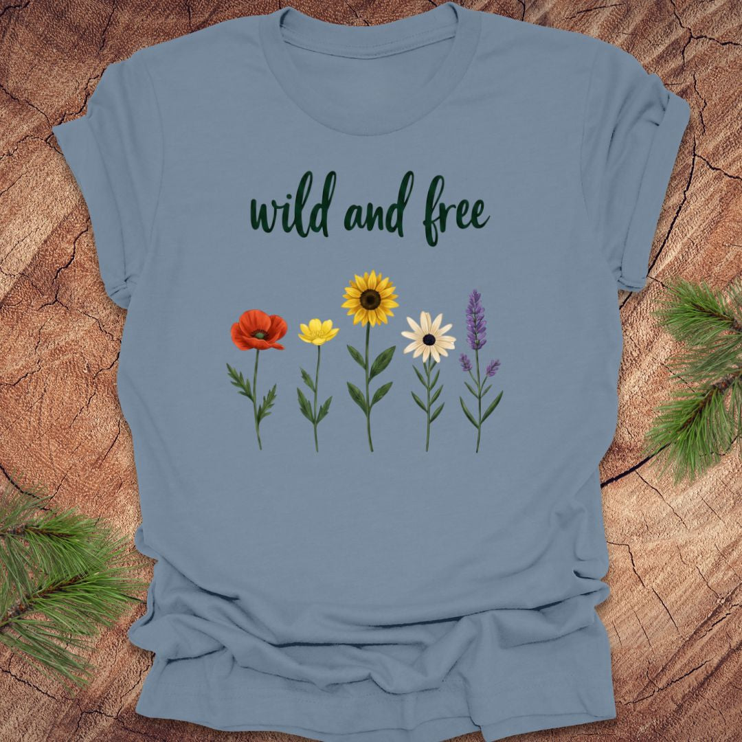 Blue t-shirt with floral design and 'wild and free' text on a wooden surface