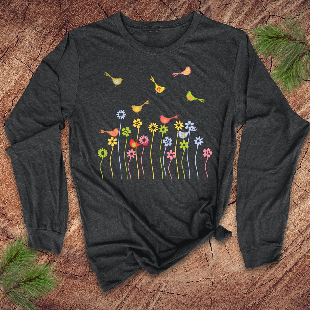 Dark gray long-sleeve shirt with colorful floral and bird design on a wooden surface.