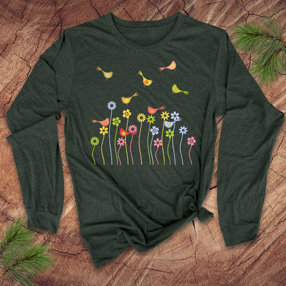 Green long-sleeve shirt with colorful floral and bird design on a wooden surface.