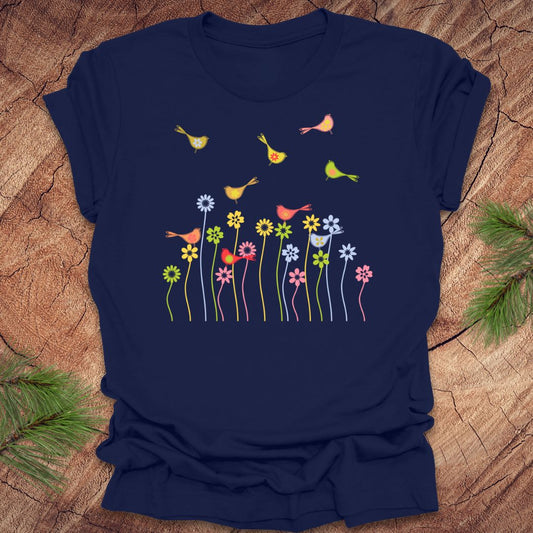 Navy blue t-shirt with colorful bird and flower design on a wooden surface
