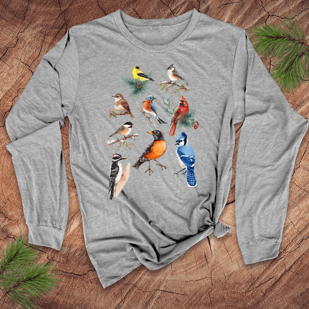 Gray long-sleeve shirt with bird illustrations on a wooden surface