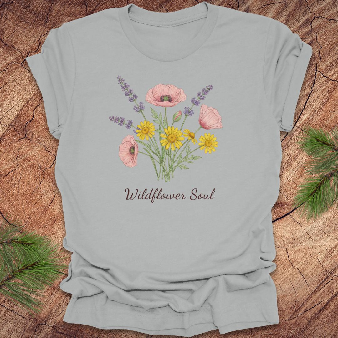 Gray t-shirt with floral design and 'Wildflower Soul' text on a wooden surface