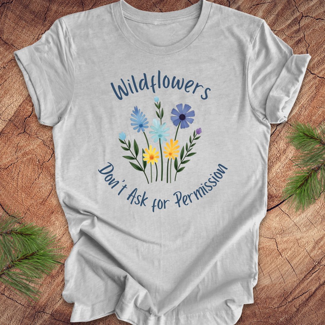 Gray t-shirt with floral design and text on a wooden surface