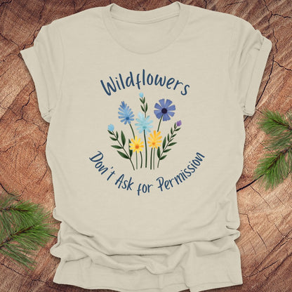 Beige t-shirt with floral design and text on a wooden surface
