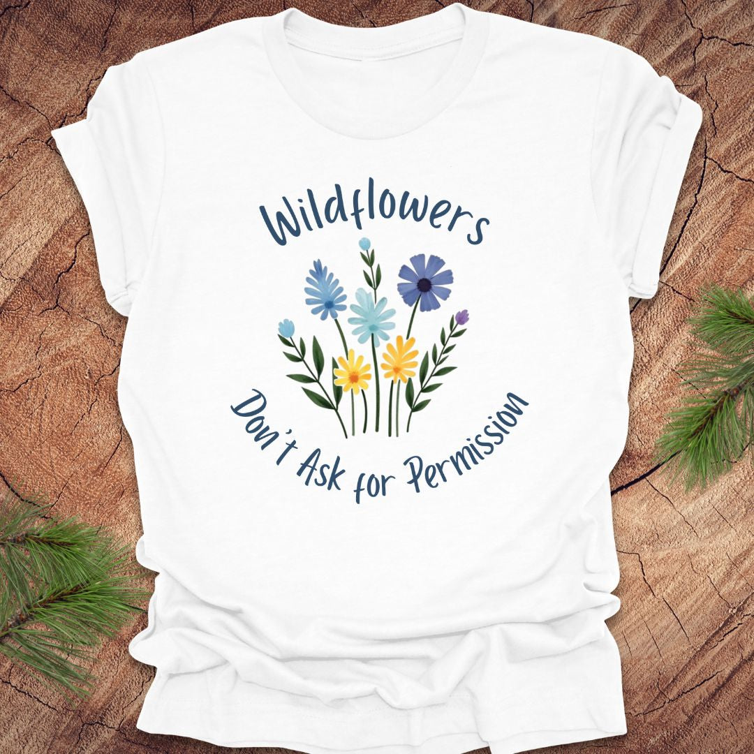 White t-shirt with floral design and text on a wooden surface