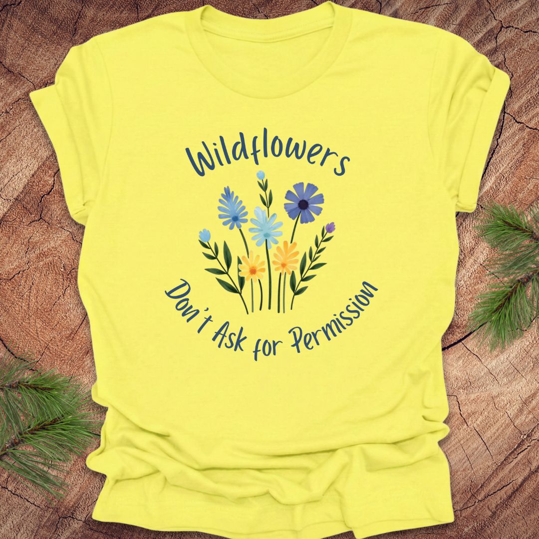 Yellow t-shirt with floral design and text on a wooden surface