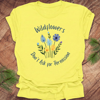 Yellow t-shirt with floral design and text on a wooden surface