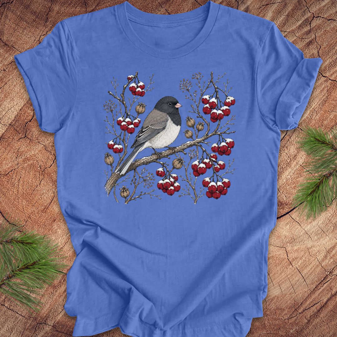 Blue t-shirt with a dark eyed junco bird and berry design on a wooden surface