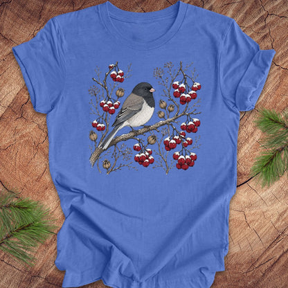 Blue t-shirt with a dark eyed junco bird and berry design on a wooden surface