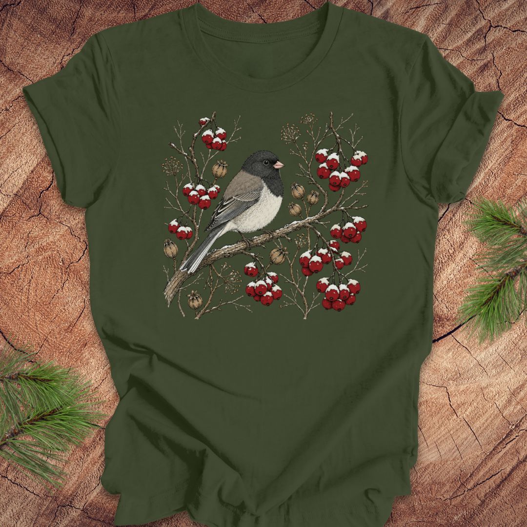 Green t-shirt with a dark eyed junco bird and berry design on a wooden surface