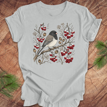 Gray t-shirt with a dark eyed junco bird and berry design on a wooden surface