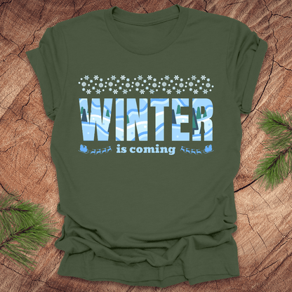 Green t-shirt with 'Winter is coming' text on a wooden surface