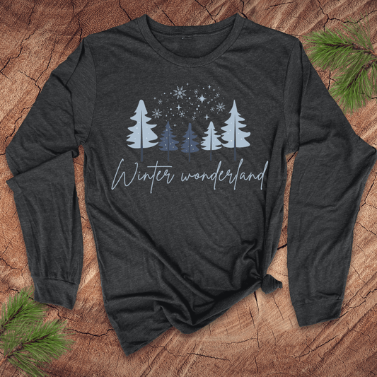 Dark long-sleeve shirt with 'Winter wonderland' text and tree design on a wooden surface.